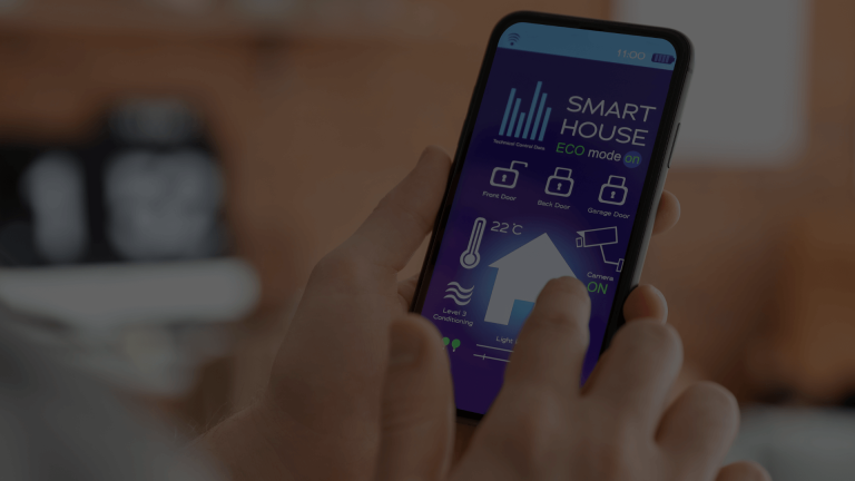 A hand holding a smartphone displaying a "SMART HOUSE ECO mode" app with controls for security, temperature, and lighting.