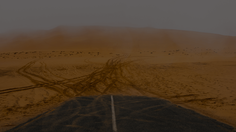 A paved road abruptly ending in a vast, sandy desert landscape with numerous tire tracks spreading out, illustrating the uncontrolled and inefficient distribution of a fast fibre connection by a standard Wi-Fi system.